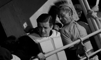 Movie still from “A Night to Remember” (1958), directed by Roy Ward Baker – A black and white photo of a man holding a baseball bat; Medium shot, High angle