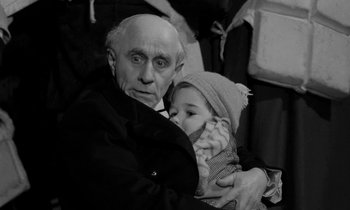 Movie still from “A Night to Remember” (1958), directed by Roy Ward Baker – An old man holding a young child in his arms; Close Up shot, High angle