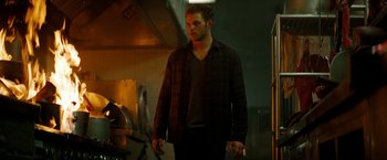 Movie still from “A Nightmare on Elm Street” (2010), directed by Samuel Bayer – A man standing in a room with a light on; Medium shot, Low angle