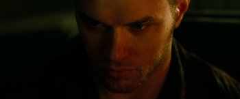 Movie still from “A Nightmare on Elm Street” (2010), directed by Samuel Bayer – A man's face in a dimly - lit room; Close Up shot, Over the shoulder angle