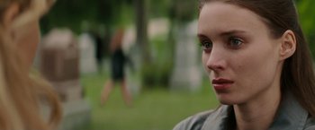 Movie still from “A Nightmare on Elm Street” (2010), directed by Samuel Bayer – A woman's face in a park setting; Close Up shot, Over the shoulder angle