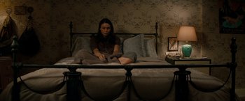 Movie still from “A Nightmare on Elm Street” (2010), directed by Samuel Bayer – A woman sitting on top of a bed in a bedroom; Medium shot, Overhead angle