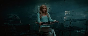 Movie still from “A Nightmare on Elm Street” (2010), directed by Samuel Bayer – A woman sitting on a chair in a dark room; Medium shot, High angle