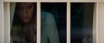 Movie still from “A Nightmare on Elm Street” (2010), directed by Samuel Bayer – A woman looking out of a window at night; Medium shot, Over the shoulder angle