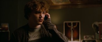 Movie still from “A Nightmare on Elm Street” (2010), directed by Samuel Bayer – A young man talking on a cell phone while standing in front of a mirror; Close Up shot, Over the shoulder angle
