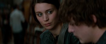 Movie still from “A Nightmare on Elm Street” (2010), directed by Samuel Bayer – A young woman looking at the camera while sitting next to a young man; Close Up shot, Over the shoulder angle