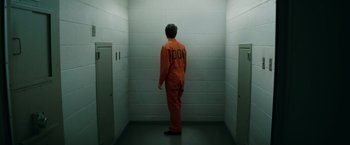 Movie still from “A Nightmare on Elm Street” (2010), directed by Samuel Bayer – A man in an orange jumpsuit standing in a jail cell; Wide shot, High angle