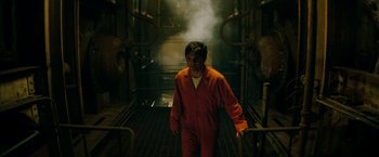 Movie still from “A Nightmare on Elm Street” (2010), directed by Samuel Bayer – A man in an orange jumpsuit walking through a tunnel; Medium shot, High angle