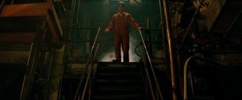 Movie still from “A Nightmare on Elm Street” (2010), directed by Samuel Bayer – A man in a red suit standing on some stairs; Wide shot, Low angle