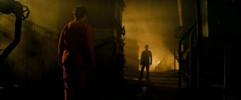 Movie still from “A Nightmare on Elm Street” (2010), directed by Samuel Bayer – A man standing in the dark holding a gun; Wide shot, Over the shoulder angle