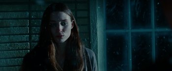 Movie still from “A Nightmare on Elm Street” (2010), directed by Samuel Bayer – A woman standing in front of a window with rain coming through the window; Close Up shot, Low angle
