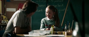 Movie still from “A Nightmare on Elm Street” (2010), directed by Samuel Bayer – A young girl sitting at a table with a man; Medium shot, Over the shoulder angle