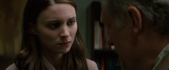 Movie still from “A Nightmare on Elm Street” (2010), directed by Samuel Bayer – A woman is looking at a man in a room with a bookshelf; Close Up shot, Over the shoulder angle