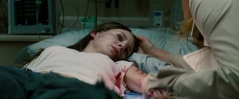 Movie still from “A Nightmare on Elm Street” (2010), directed by Samuel Bayer – A woman laying in a hospital bed with her hand on her head; Close Up shot, High angle