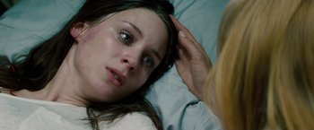 Movie still from “A Nightmare on Elm Street” (2010), directed by Samuel Bayer – A woman laying in a bed with her hand on her head; Close Up shot, Overhead angle