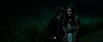 Movie still from “A Nightmare on Elm Street” (2010), directed by Samuel Bayer – A man and a woman standing next to each other in the dark; Medium shot, Over the shoulder angle