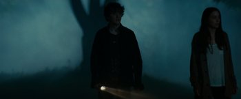 Movie still from “A Nightmare on Elm Street” (2010), directed by Samuel Bayer – A man standing in the dark holding a flashlight; Medium shot, Low angle