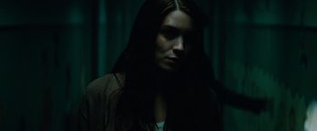 Movie still from “A Nightmare on Elm Street” (2010), directed by Samuel Bayer – A woman with long dark hair standing in the dark; Close Up shot, Low angle