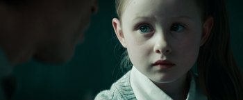 Movie still from “A Nightmare on Elm Street” (2010), directed by Samuel Bayer – A little girl with blue eyes stares at the camera; Close Up shot, Over the shoulder angle