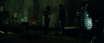Movie still from “A Nightmare on Elm Street” (2010), directed by Samuel Bayer – Two people standing in a dark room looking at a cell phone; Wide shot, Low angle