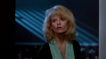 Movie still from “A Nightmare on Elm Street 3: Dream Warriors” (1987), directed by Chuck Russell – A woman with blonde hair wearing a black and green shirt; Close Up shot, Low angle