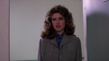 Movie still from “A Nightmare on Elm Street 3: Dream Warriors” (1987), directed by Chuck Russell – A woman in a jacket and a tie looking at the camera; Close Up shot, Over the shoulder angle