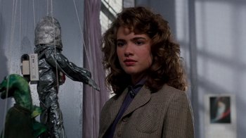 Movie still from “A Nightmare on Elm Street 3: Dream Warriors” (1987), directed by Chuck Russell – A woman in a suit and tie standing next to a window; Close Up shot, Over the shoulder angle