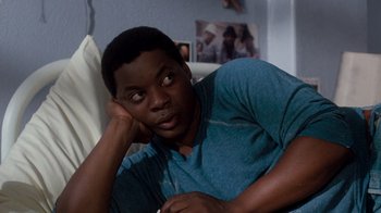 Movie still from “A Nightmare on Elm Street 3: Dream Warriors” (1987), directed by Chuck Russell – A man sitting on a couch with his head resting on his hand; Close Up shot, Over the shoulder angle