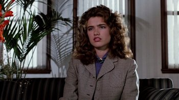 Movie still from “A Nightmare on Elm Street 3: Dream Warriors” (1987), directed by Chuck Russell – A woman in a jacket and tie sitting in front of a window; Close Up shot, Over the shoulder angle