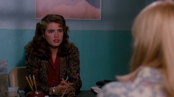 Movie still from “A Nightmare on Elm Street 3: Dream Warriors” (1987), directed by Chuck Russell – A woman sitting at a table with a pen in her hand; Medium shot, Over the shoulder angle