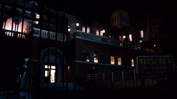 Movie still from “A Nightmare on Elm Street 3: Dream Warriors” (1987), directed by Chuck Russell – A building that is lit up at night time; Extreme Wide shot, Low angle