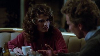 Movie still from “A Nightmare on Elm Street 3: Dream Warriors” (1987), directed by Chuck Russell – A woman sitting in front of a man at a table; Close Up shot, Over the shoulder angle