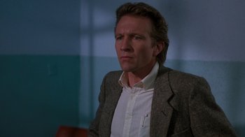 Movie still from “A Nightmare on Elm Street 3: Dream Warriors” (1987), directed by Chuck Russell – A person wearing a suit and tie; Close Up shot, Low angle