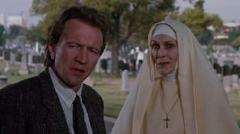 Movie still from “A Nightmare on Elm Street 3: Dream Warriors” (1987), directed by Chuck Russell – A man and a woman standing next to each other in a cemetery; Close Up shot, Low angle