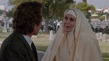 Movie still from “A Nightmare on Elm Street 3: Dream Warriors” (1987), directed by Chuck Russell – An older woman wearing a nun's outfit talking to a young man; Close Up shot, Over the shoulder angle
