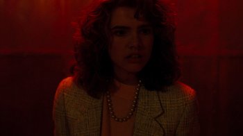 Movie still from “A Nightmare on Elm Street 3: Dream Warriors” (1987), directed by Chuck Russell – A woman with curly red hair wearing a jacket and a necklace; Close Up shot, Low angle