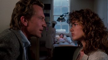 Movie still from “A Nightmare on Elm Street 3: Dream Warriors” (1987), directed by Chuck Russell – A man and a woman face each other in front of a bed; Close Up shot, Over the shoulder angle