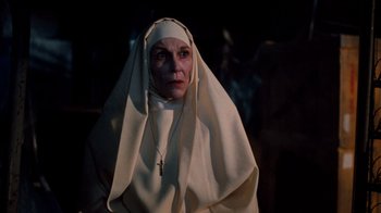 Movie still from “A Nightmare on Elm Street 3: Dream Warriors” (1987), directed by Chuck Russell – An old woman wearing a nun's outfit and a cross necklace; Close Up shot, Low angle