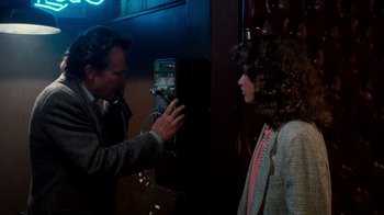 Movie still from “A Nightmare on Elm Street 3: Dream Warriors” (1987), directed by Chuck Russell – A man and a woman talking to each other in front of a phone; Medium shot, Low angle