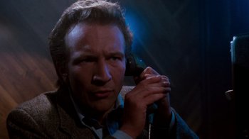 Movie still from “A Nightmare on Elm Street 3: Dream Warriors” (1987), directed by Chuck Russell – A man holding a phone up to his ear; Close Up shot, Low angle