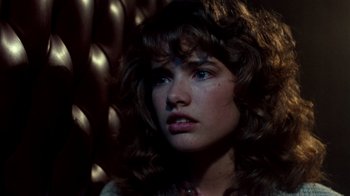 Movie still from “A Nightmare on Elm Street 3: Dream Warriors” (1987), directed by Chuck Russell – A person with long curly hair; Close Up shot, Over the shoulder angle