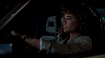Movie still from “A Nightmare on Elm Street 3: Dream Warriors” (1987), directed by Chuck Russell – A woman sitting in the driver's seat of a car at night; Close Up shot, Over the shoulder angle