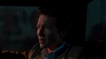 Movie still from “A Nightmare on Elm Street 3: Dream Warriors” (1987), directed by Chuck Russell – A person wearing a suit and tie; Close Up shot, Over the shoulder angle