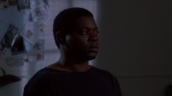 Movie still from “A Nightmare on Elm Street 3: Dream Warriors” (1987), directed by Chuck Russell – A man with a black t - shirt is looking up; Close Up shot, Low angle