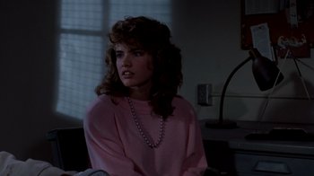 Movie still from “A Nightmare on Elm Street 3: Dream Warriors” (1987), directed by Chuck Russell – A woman in a pink sweater and a necklace; Close Up shot, Over the shoulder angle