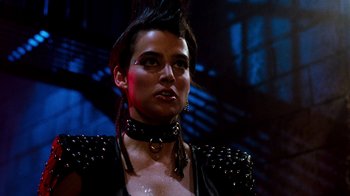 Movie still from “A Nightmare on Elm Street 3: Dream Warriors” (1987), directed by Chuck Russell – A woman in a black leather outfit with spikes on her neck; Close Up shot, Low angle