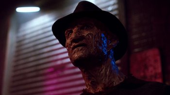 Movie still from “A Nightmare on Elm Street 3: Dream Warriors” (1987), directed by Chuck Russell – The face of an old man wearing a fedora; Close Up shot, Low angle