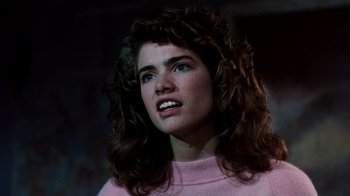 Movie still from “A Nightmare on Elm Street 3: Dream Warriors” (1987), directed by Chuck Russell – A woman with long brown hair wearing a pink sweater; Close Up shot, Over the shoulder angle