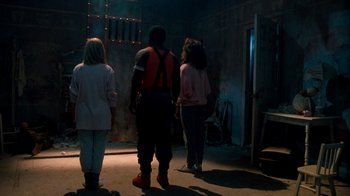 Movie still from “A Nightmare on Elm Street 3: Dream Warriors” (1987), directed by Chuck Russell – A group of people standing in a dark room; Wide shot, Low angle