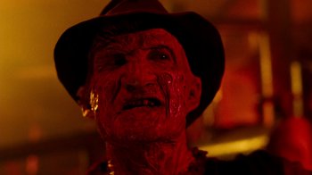 Movie still from “A Nightmare on Elm Street 3: Dream Warriors” (1987), directed by Chuck Russell – An old man wearing a hat and a fake blood covered face; Close Up shot, Low angle